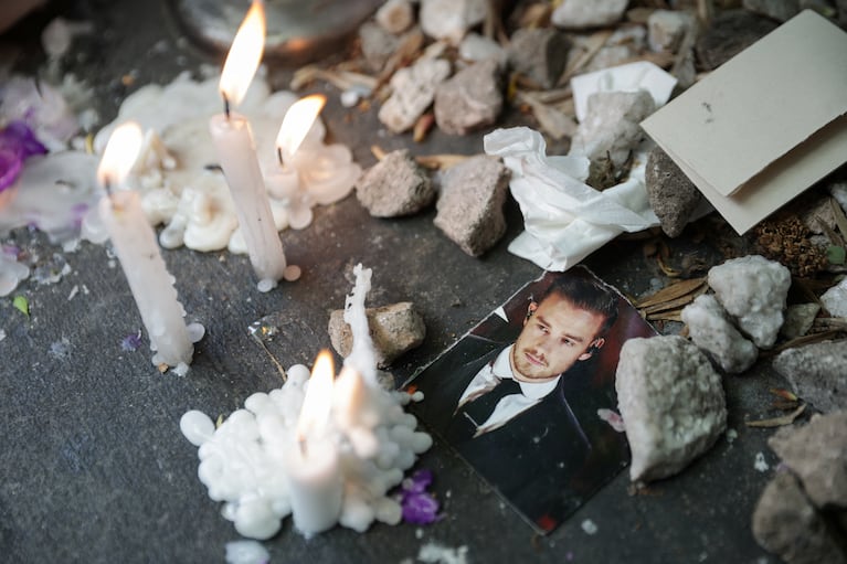 A picture of Liam Payne lays next to lit candles outside the hotel where Liam Payne, former One Direction band member, was found dead after he fell from a third-floor hotel room balcony, in Buenos Aires, Argentina, October 17, 2024. REUTERS/Tomas Cuesta