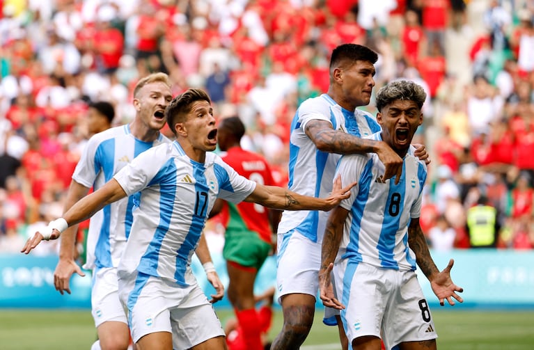 Paris 2024 Olympics - Football - Men's Group B - Argentina vs Morocco - Geoffroy-Guichard Stadium, Saint-Etienne, France - July 24, 2024. Cristian Medina of Argentina celebrates scoring their second goal with teammates. REUTERS/Thaier Al-Sudani